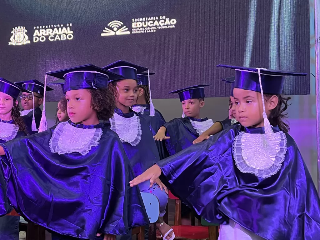 Pais e alunos comemorando a formatura na cidade de Arraial do Cabo